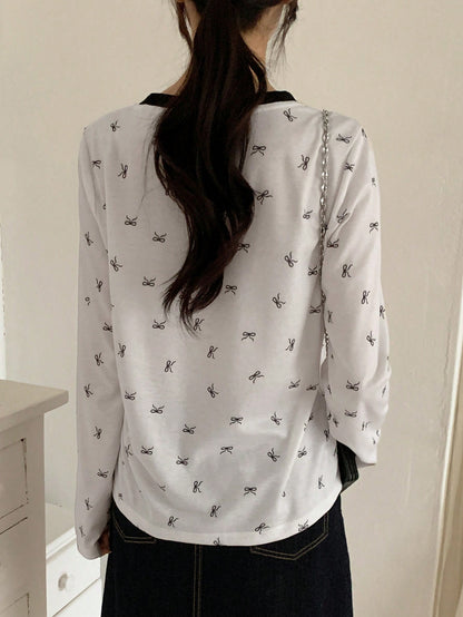 DAZY Camiseta de manga larga con cuello redondo y estampado de moño para mujer