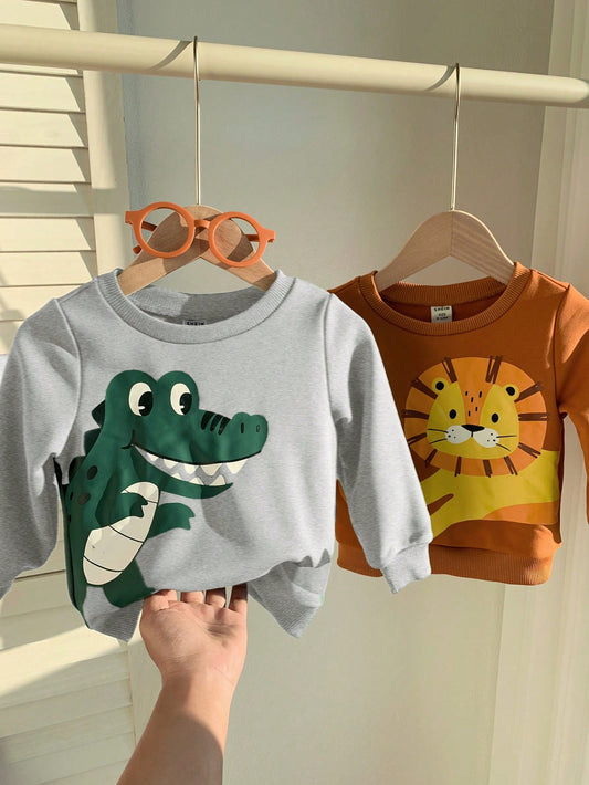 SHEIN 2 piezas Sudadera de cuello redondo acanalado con estampado de león y cocodrilo de dibujos animados para niño/niña, estilo informal y lindo, a juego para otoño/invierno, cómodo para usar en casa y al aire libre