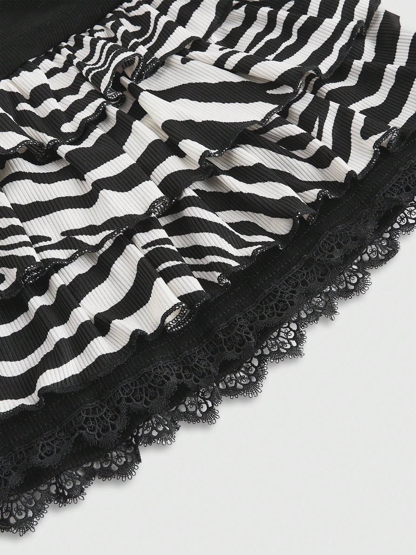 ROMWE Avant Minifalda minimalista con estampado de cebra Shibuya, con bajo de encaje y nudo delantero casual para mujer
