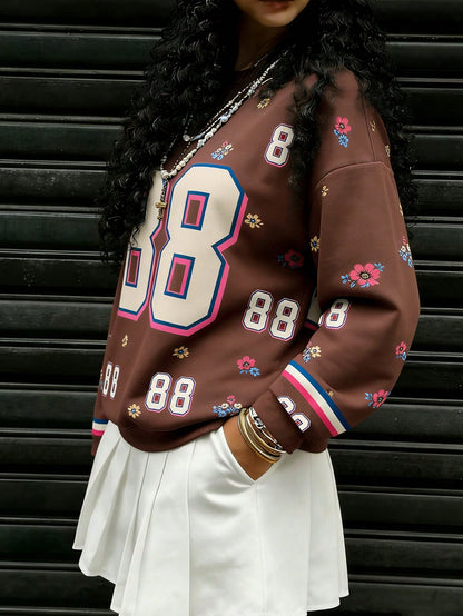 Rovax Sudadera casual de mujer con cuello redondo y hombros caídos, con estampado floral y numérico, para otoño